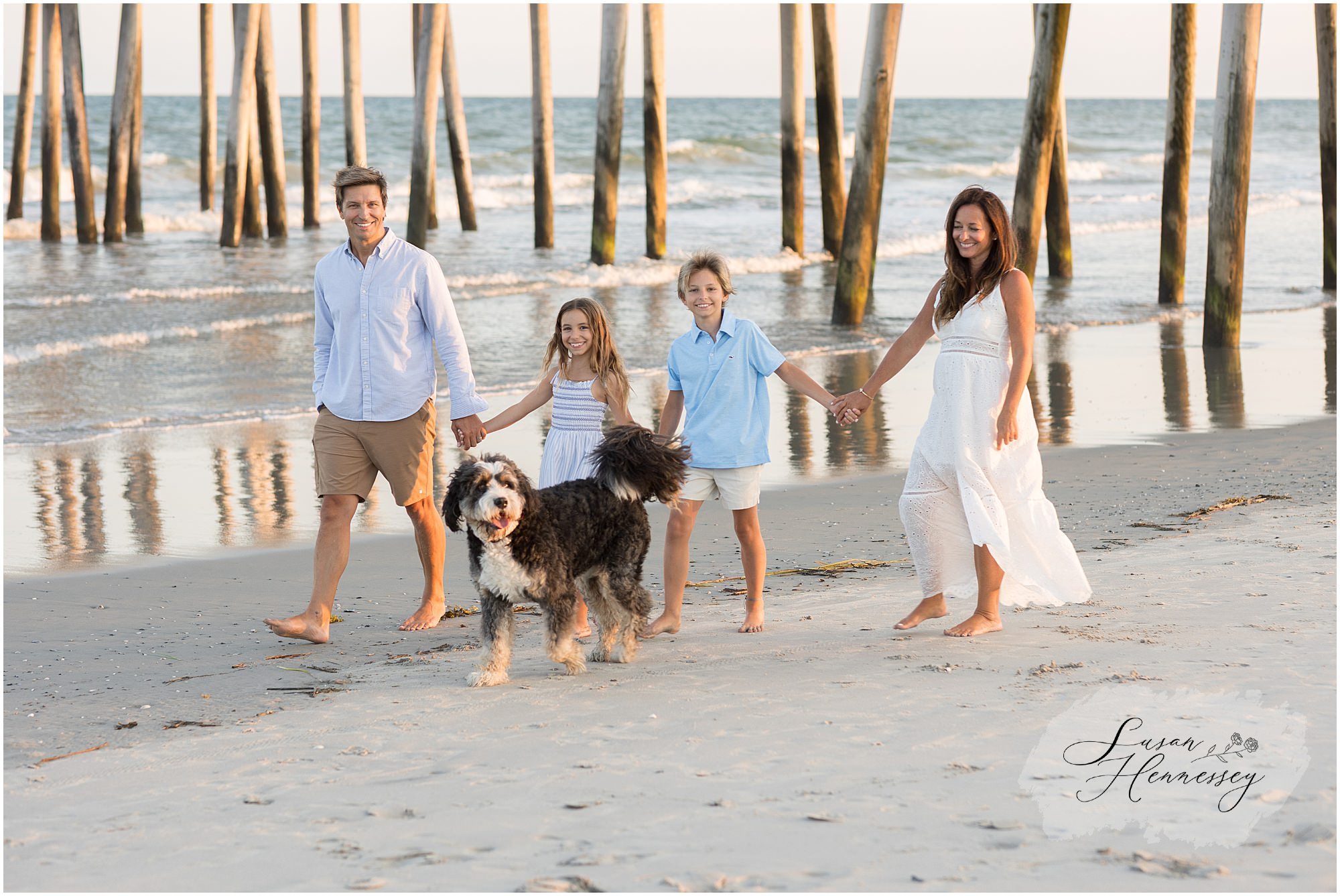 Family walking along the beach during a Jersey Shore family photography session at sunset