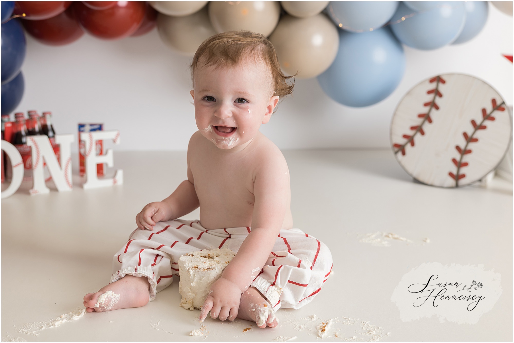 baby boy Phillies cake smash with red blue balloon arch