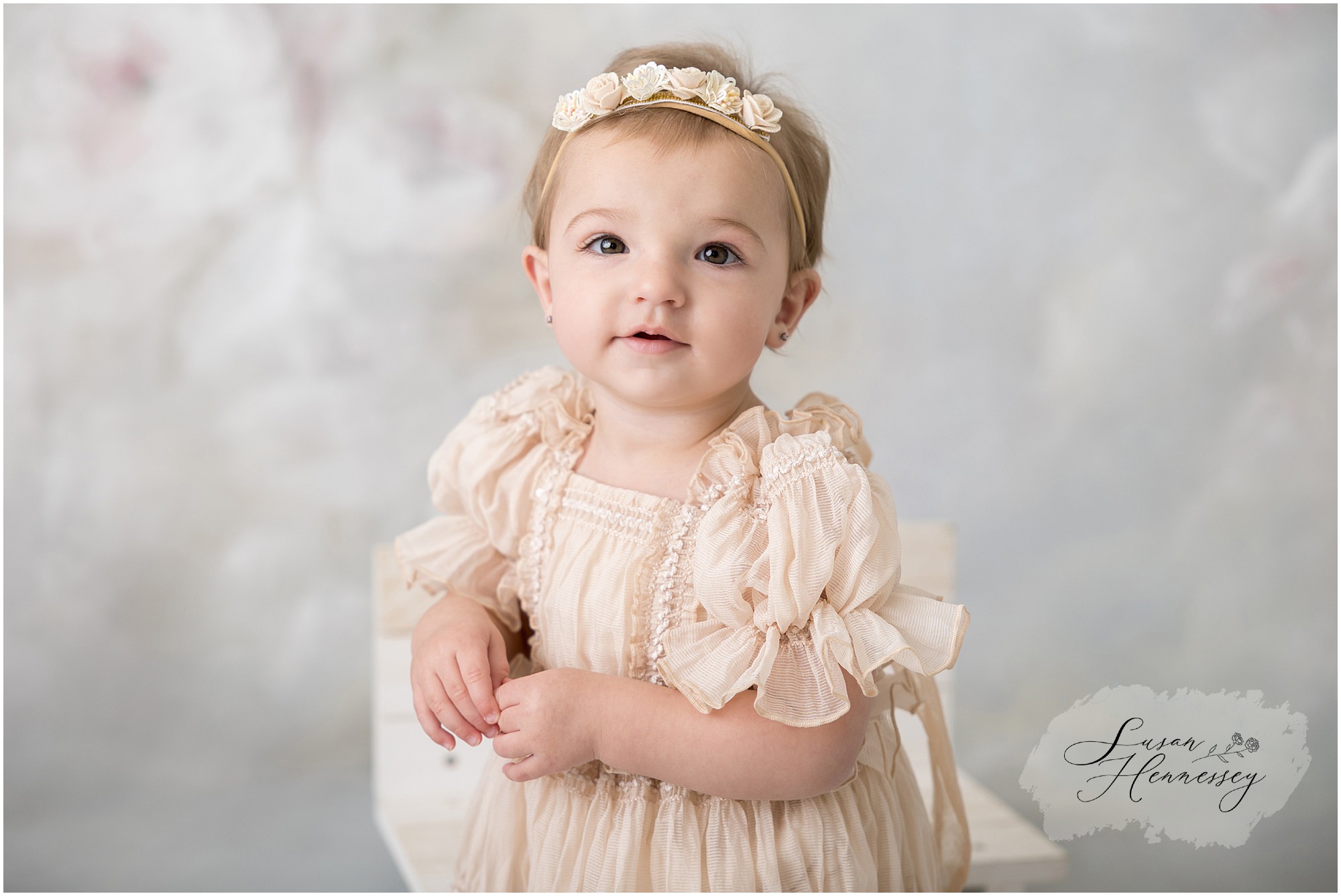 Classic first birthday portrait of one year old girl on floral backdrop in South Jersey photography studio