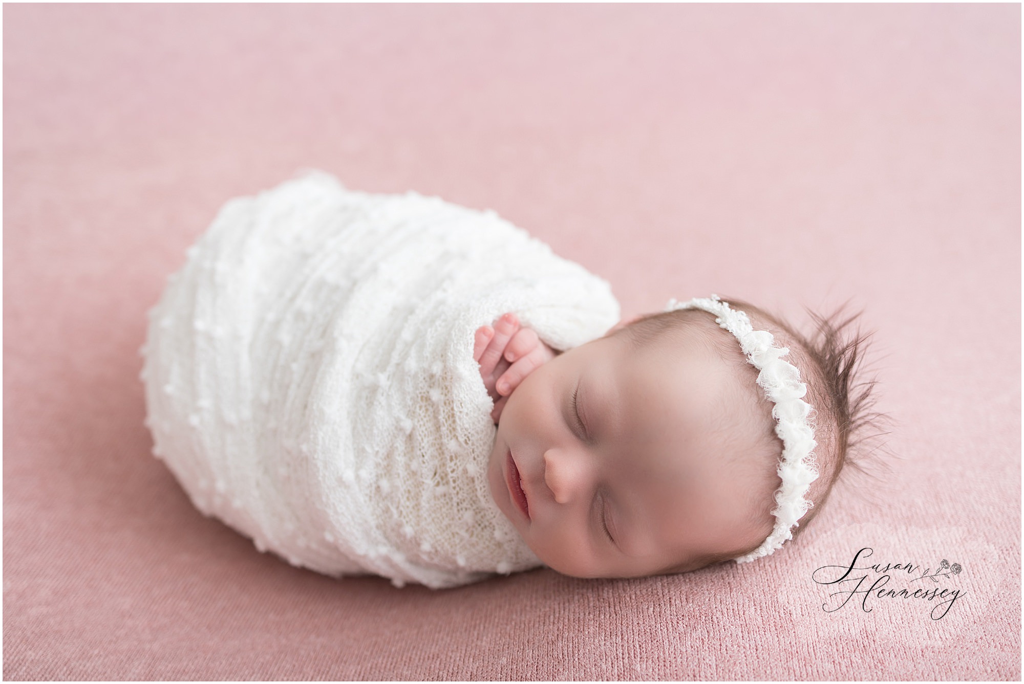 Newborn baby girl wrapped in cream fabric at South Jersey newborn photography studio
