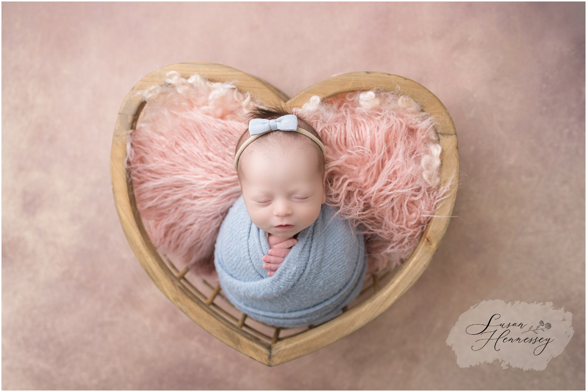 Baby Isabel posed in a basket during South Jersey newborn photography studio session