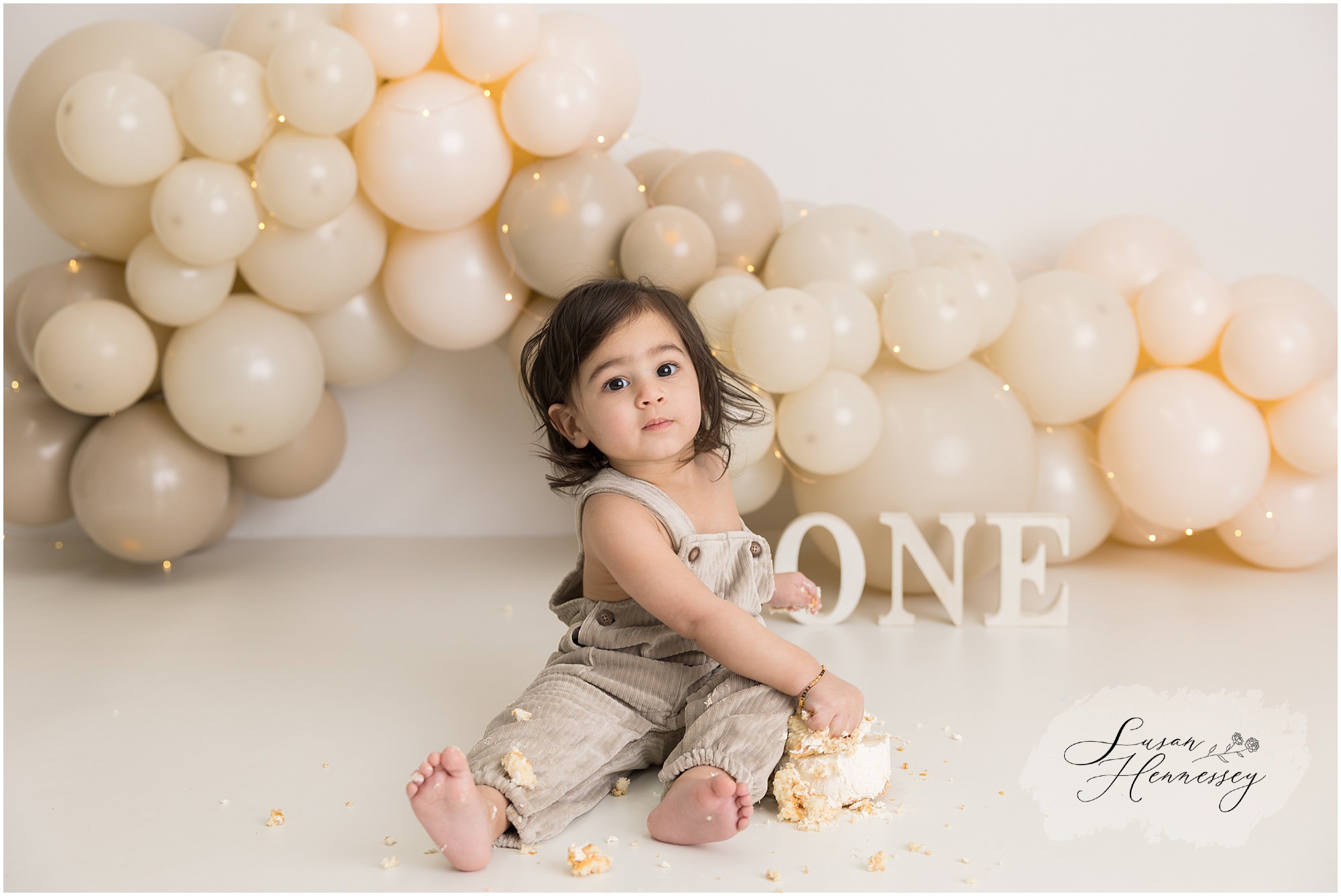 Shyam exploring his birthday cake during a neutral cake smash session