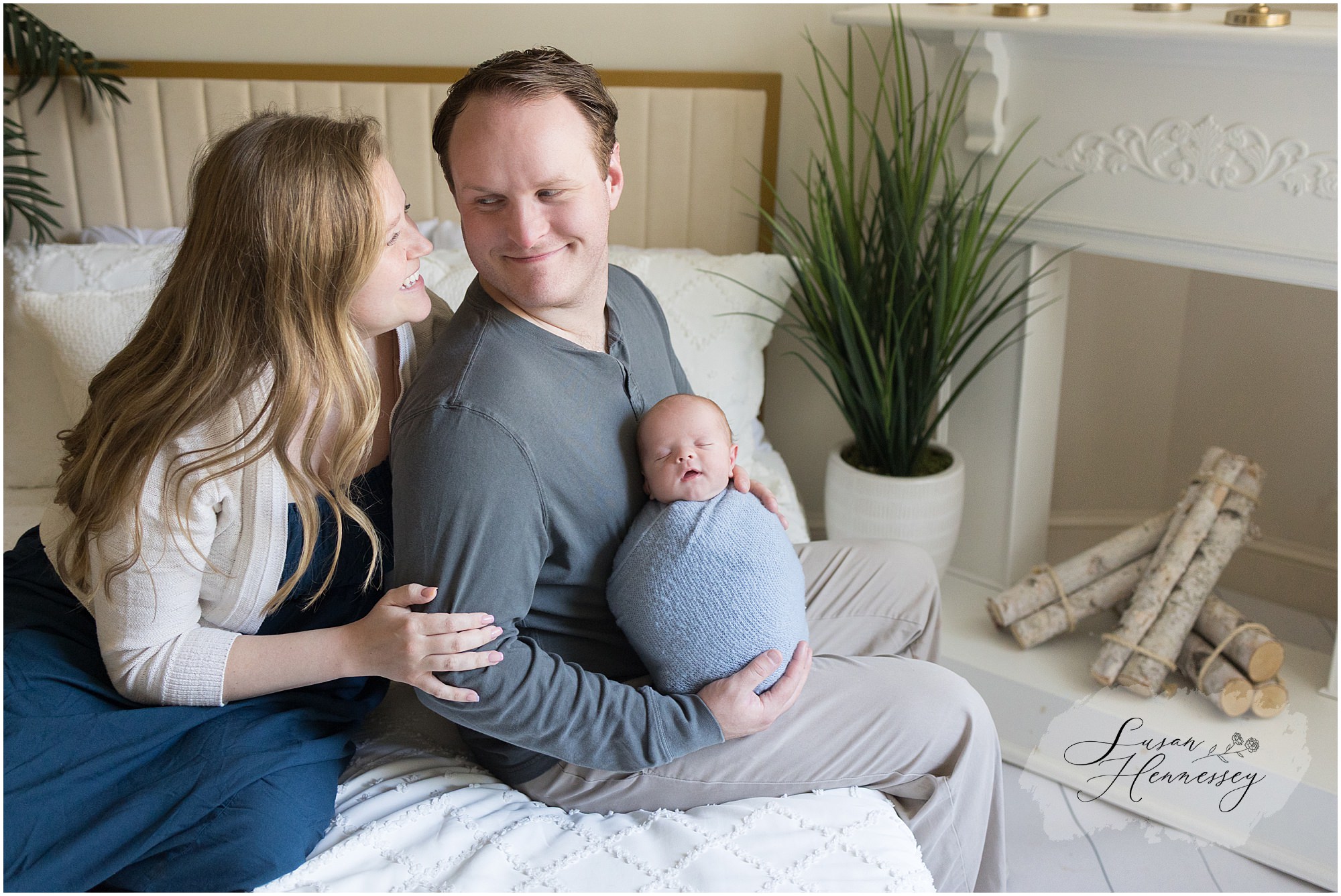 New parents holding baby Jack during their South Jersey studio newborn session.