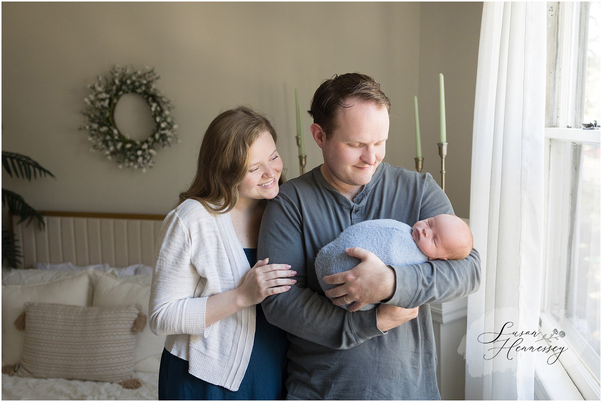 Parents cuddling newborn baby Jack during a timeless newborn photography session.