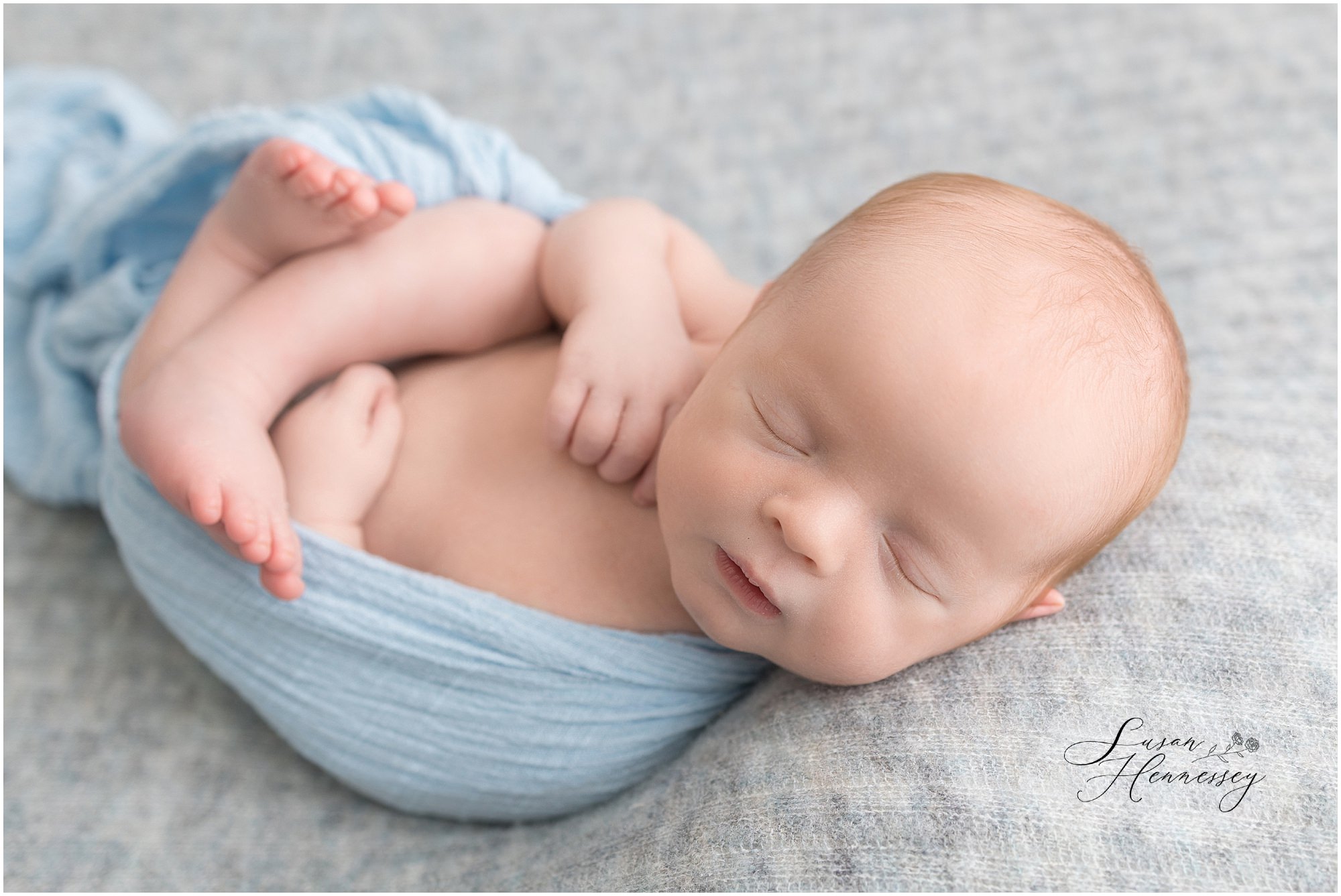 South Jersey studio newborn photography featuring baby Jack in soft blue wraps.